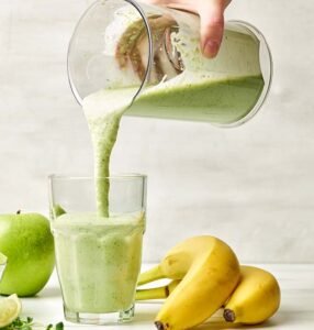 fresh green smoothie pouring into glass 4alm7ta.jpg